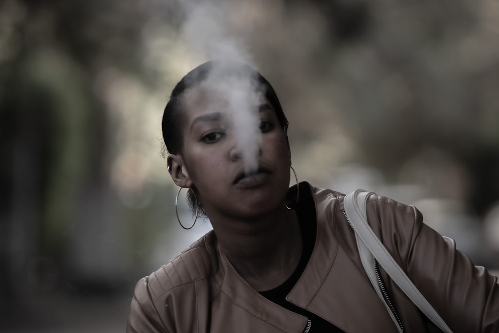 a woman with smoke coming out of her mouth