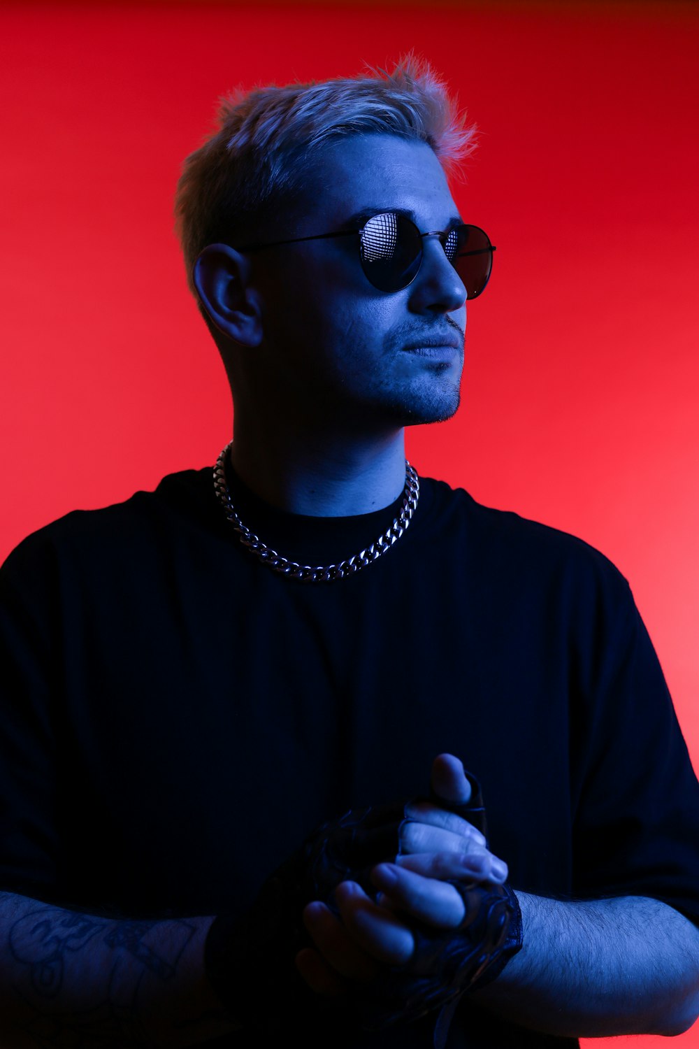 a man in a black shirt and sunglasses