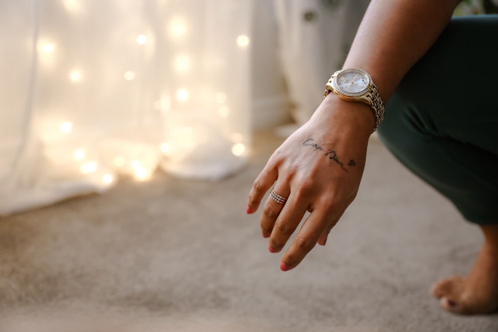 a woman's hand with a tattoo on it