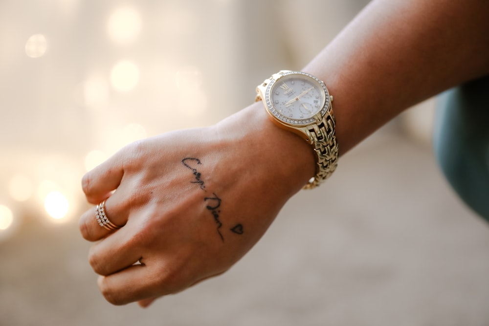 a close up of a person with a wrist tattoo