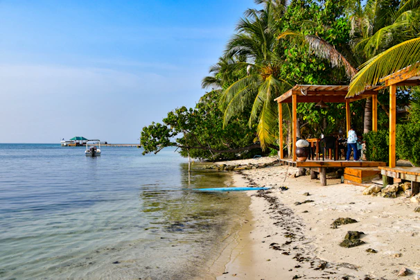 A peaceful private island in Mexico featuring a sandy beach and a small dock with a boat.