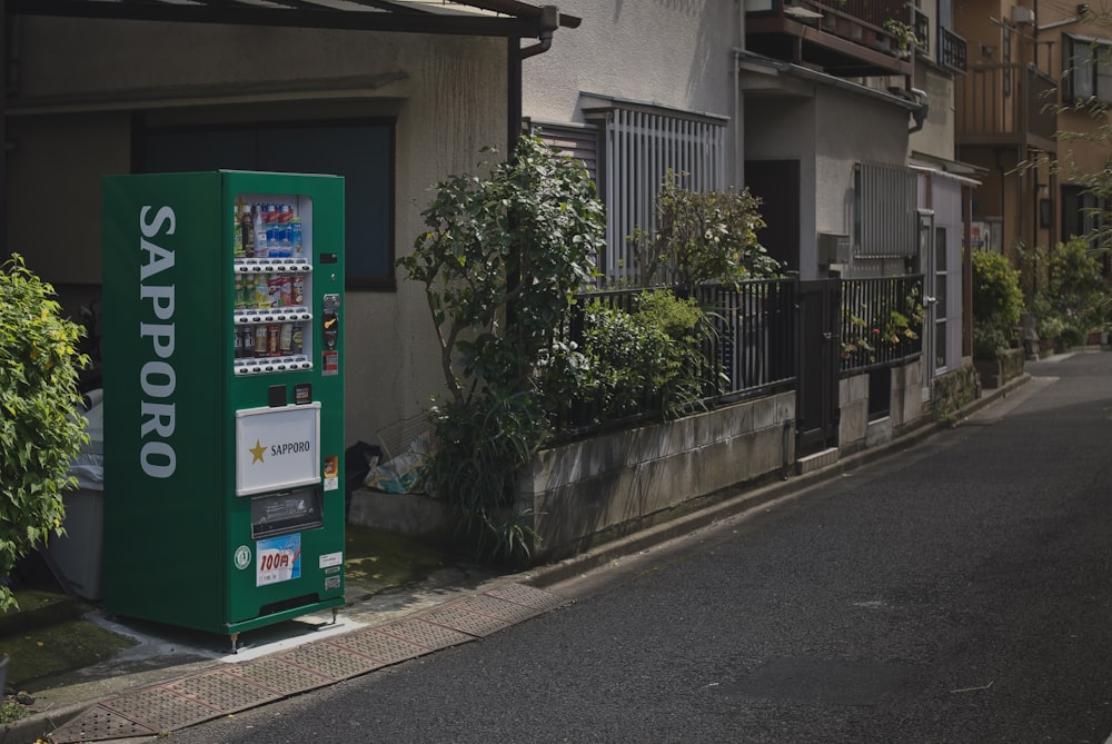 a vending machine sitting on the side of a street