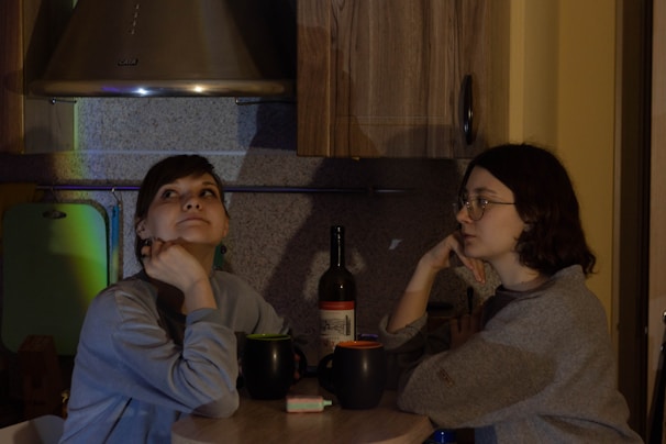 An inviting scene showing a couple thoughtfully answering questions together at a cozy kitchen table.