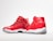 A pair of red high-top sneakers with glossy finish and white soles. One shoe is positioned facing forward, while the other is angled to show the side profile. The design features mesh fabric and a distinct black logo on the heel.