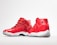 A pair of red high-top sneakers with glossy finish and white soles. One shoe is positioned facing forward, while the other is angled to show the side profile. The design features mesh fabric and a distinct black logo on the heel.