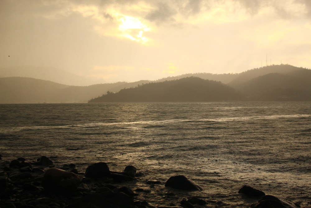 a body of water with a mountain in the background