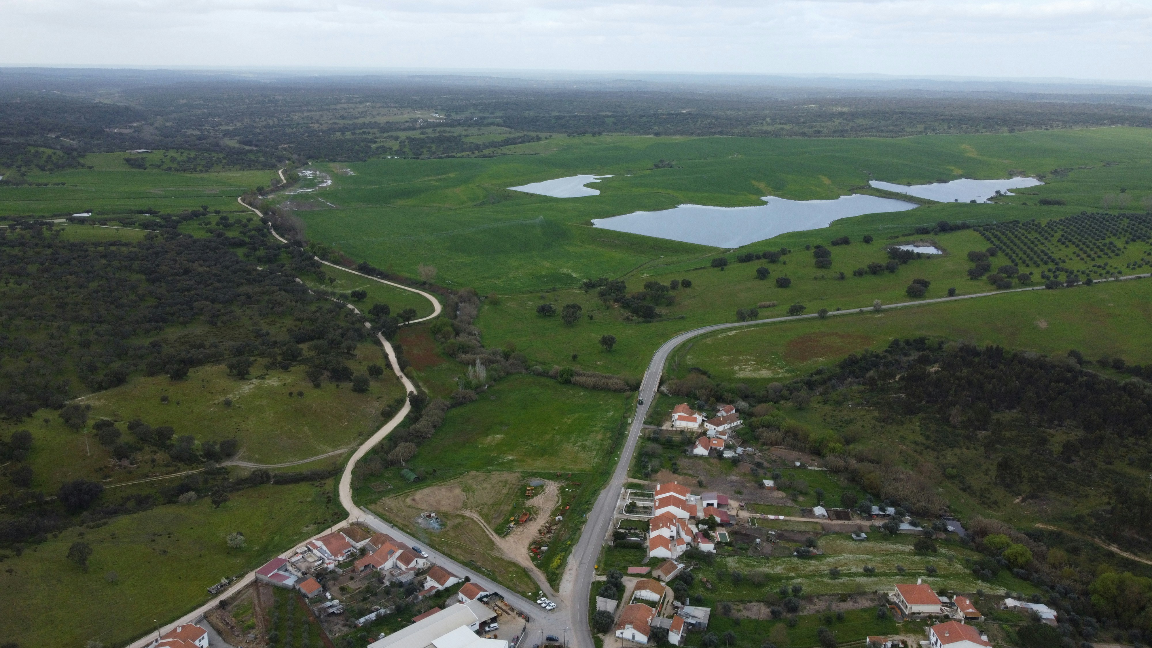 an aerial view of a small town and a lake