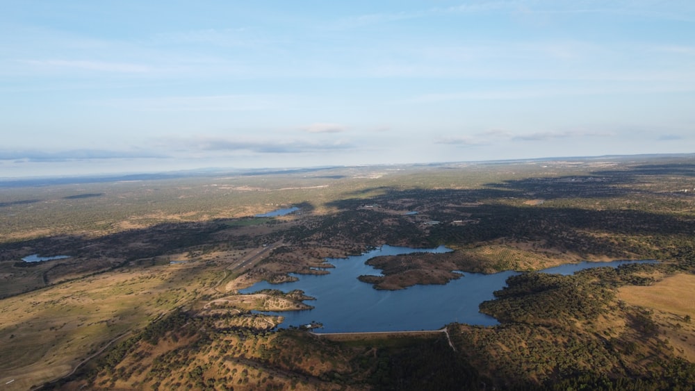 an aerial view of a lake surrounded by trees