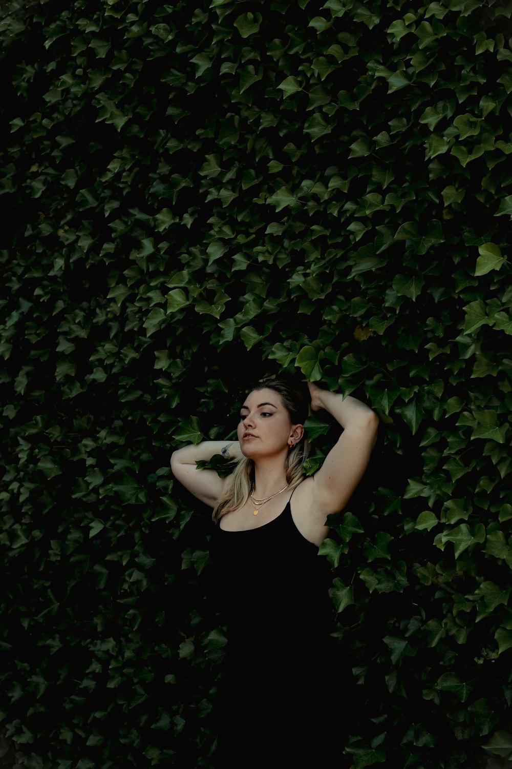 a woman standing in front of a green wall