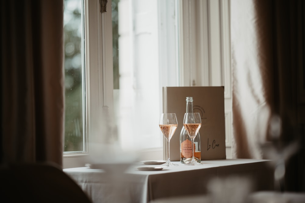 a couple of wine glasses sitting on top of a table