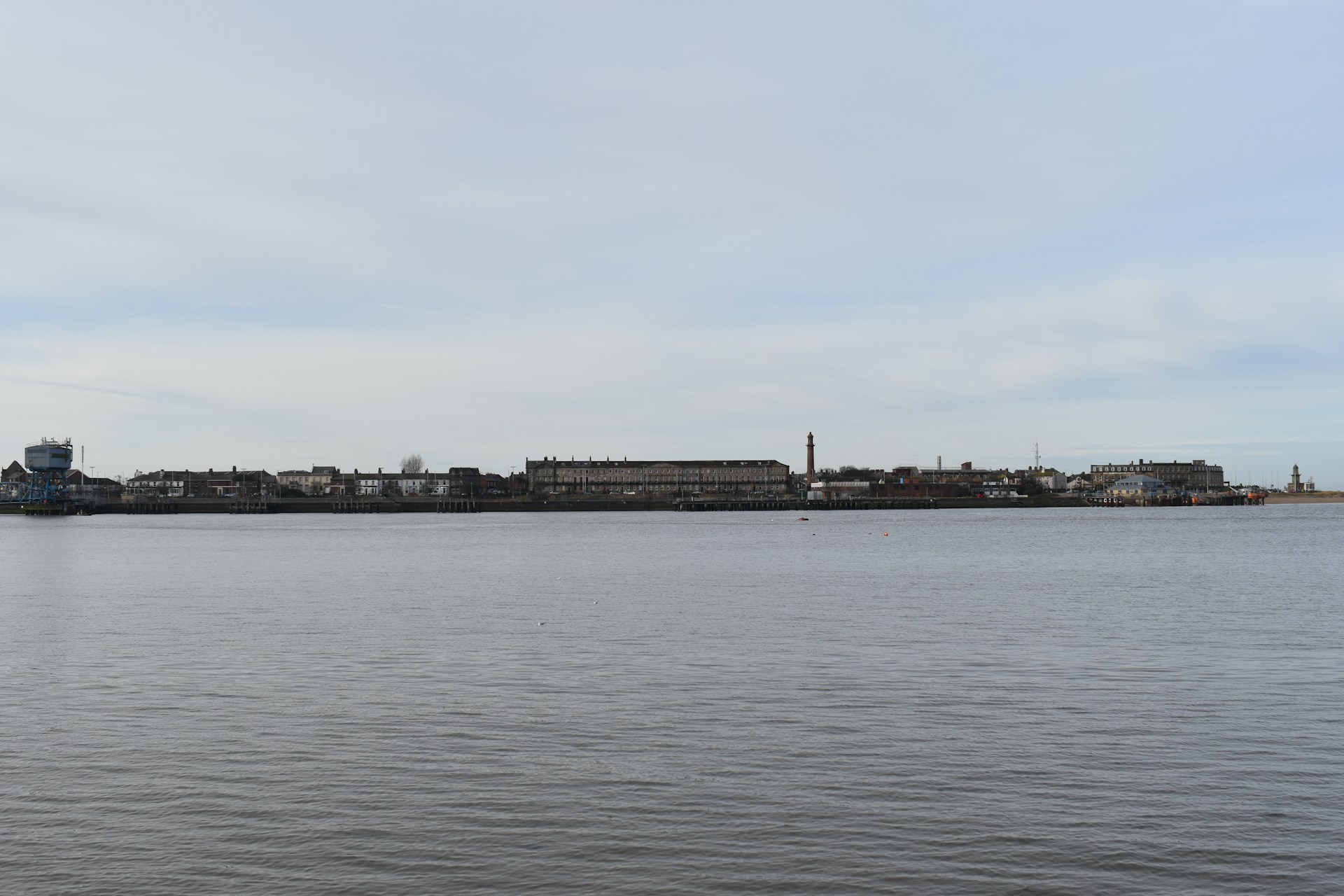 a large body of water with a city in the background