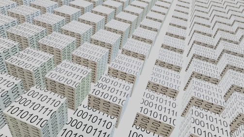 An abstract scene featuring numerous 3D cubes arranged in a grid-like pattern, each covered with binary code 0s and 1s. The perspective and repetition create a sense of depth and complexity, suggesting a digital or technological theme.