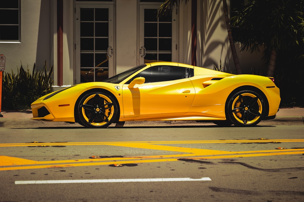 a yellow sports car parked in front of a building