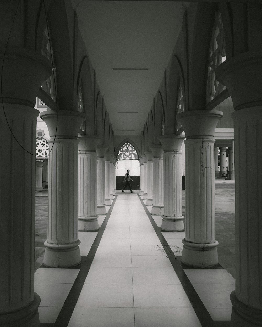 a person sitting on a bench in a building