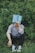 a man sitting in the grass with a book on his head
