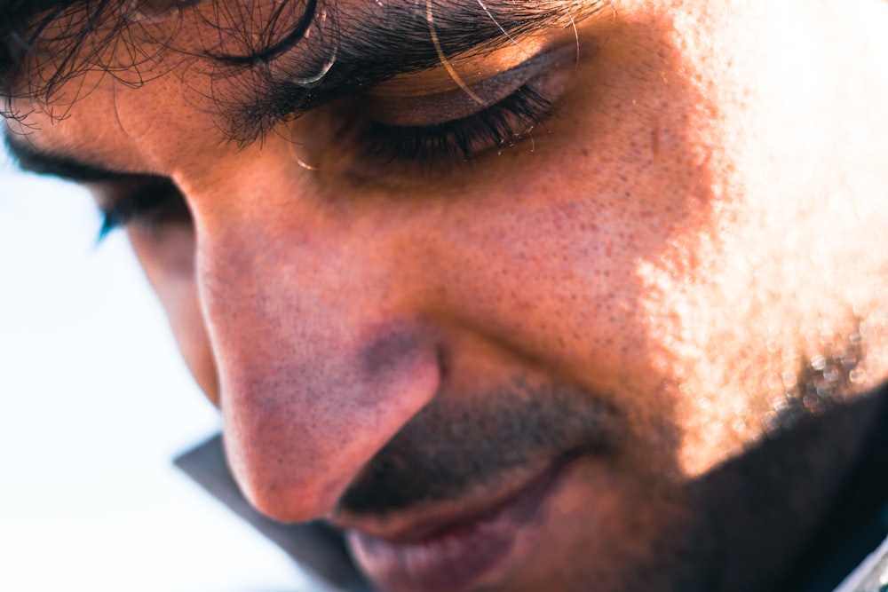 a close up of a man talking on a cell phone