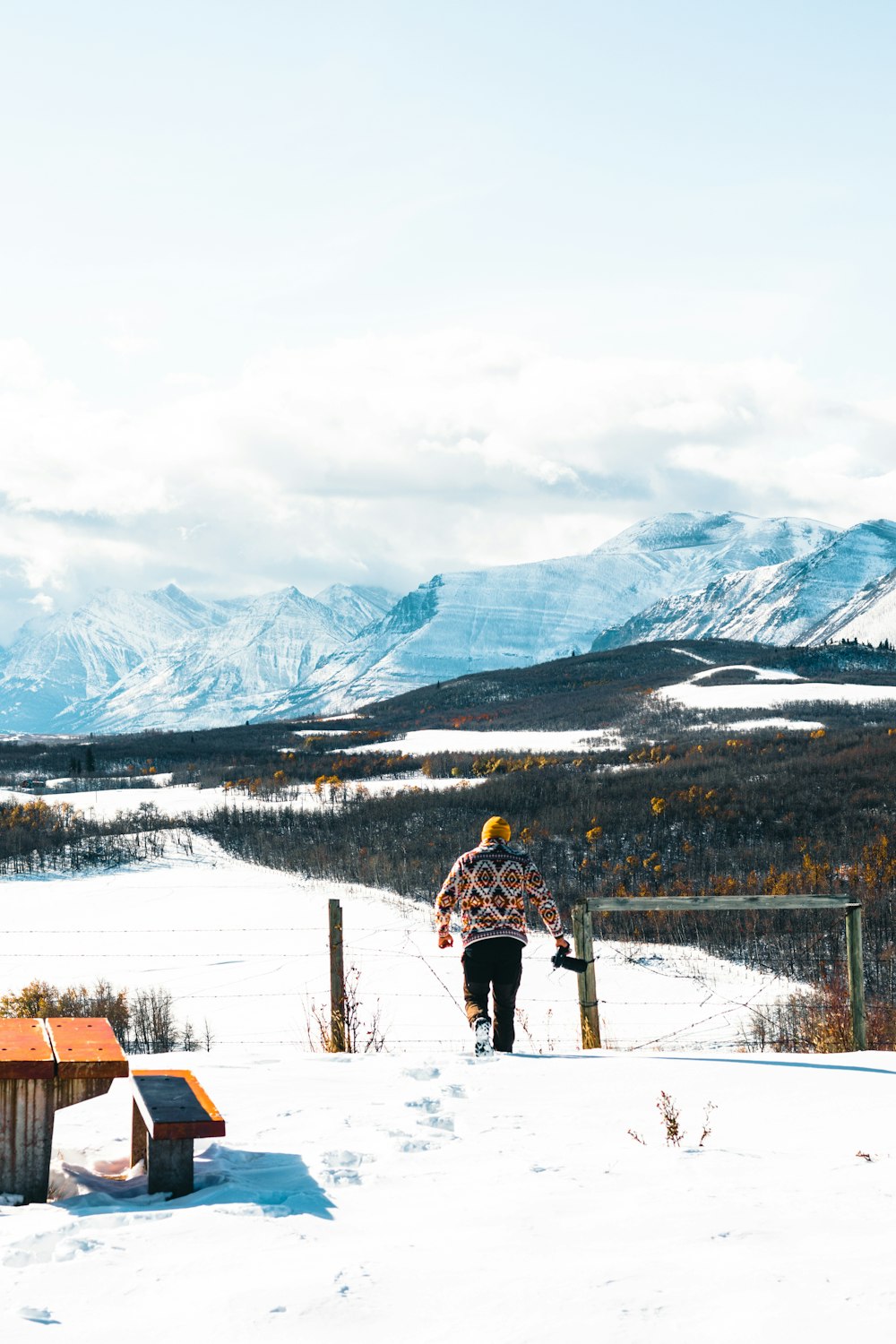 a person on skis in the snow with mountains in the background