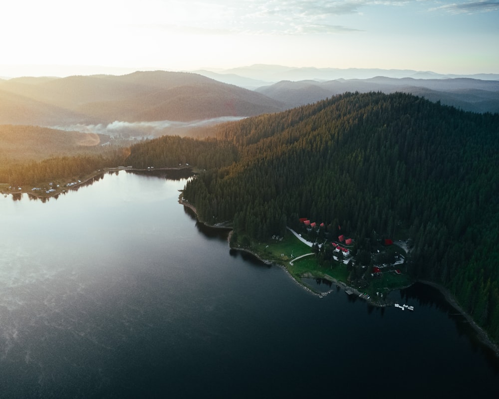 an aerial view of a lake surrounded by mountains