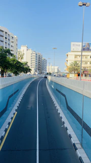 A busy Riyadh street freshly painted with bright, clear road safety markings under a sunny sky.