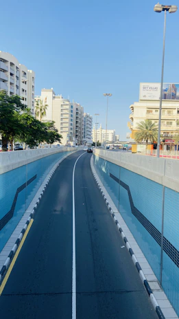 A busy Riyadh street freshly painted with bright, clear road safety markings under a sunny sky.
