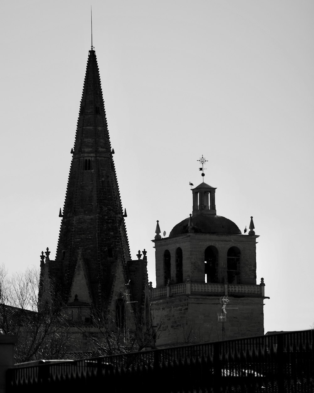 a black and white photo of a church steeple