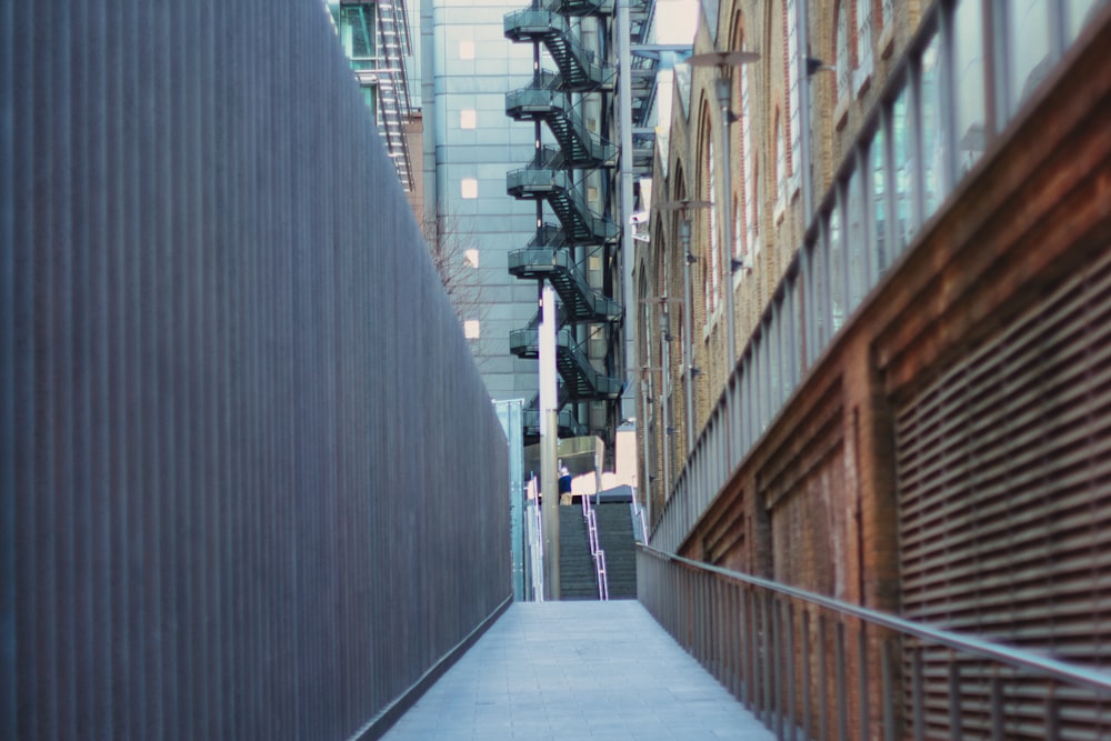 a narrow city street with buildings and stairs