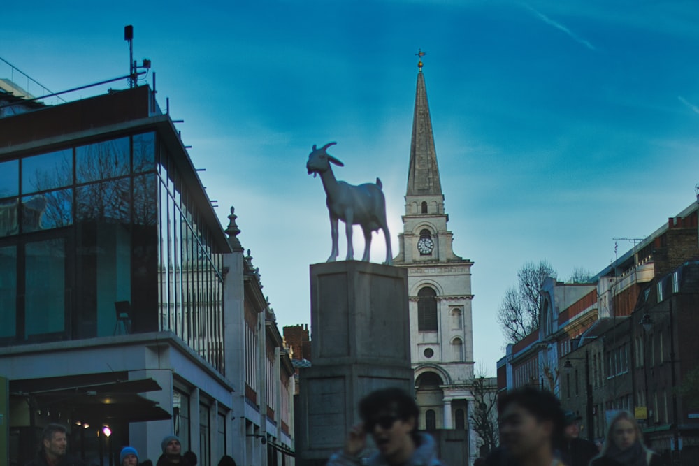 a statue of a goat on top of a building