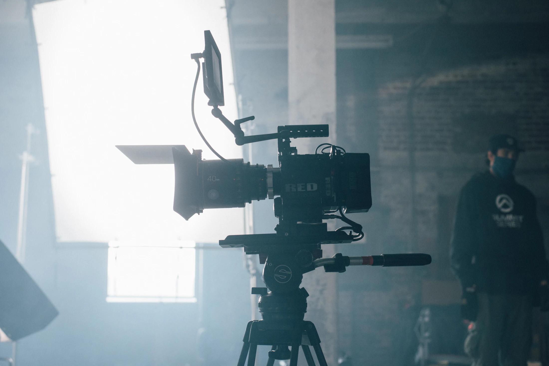Cinema camera silhouetted in atmospheric light