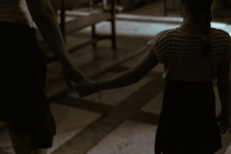 Parents holding hands with their child walking into Apex Kidz Hospital's modern entrance.