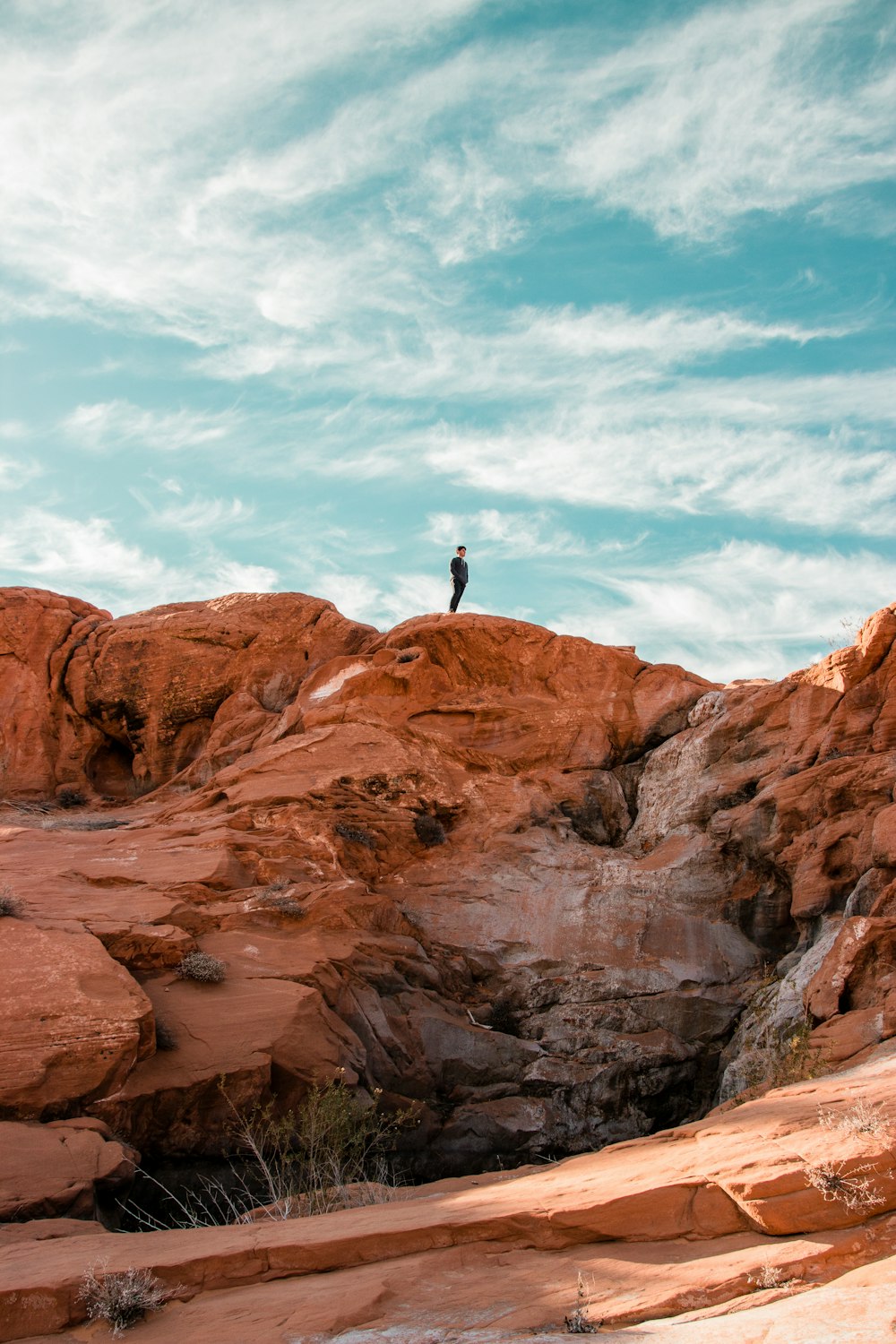 a person standing on top of a rock formation