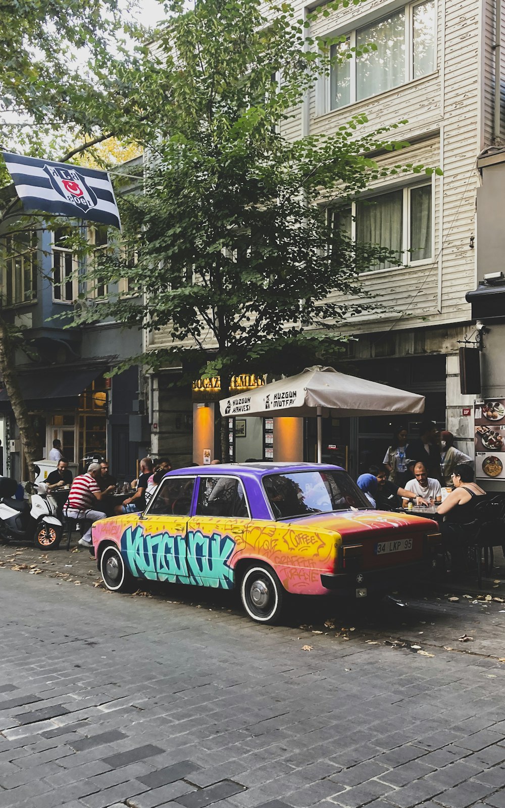 a colorful car parked on the side of the road