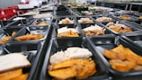 a bunch of trays filled with different types of food