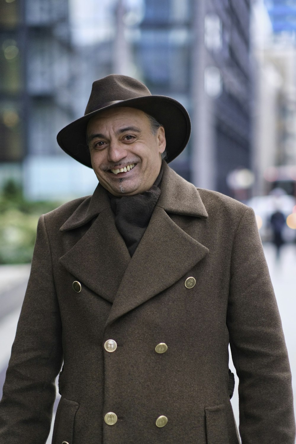 a man wearing a brown coat and a brown hat