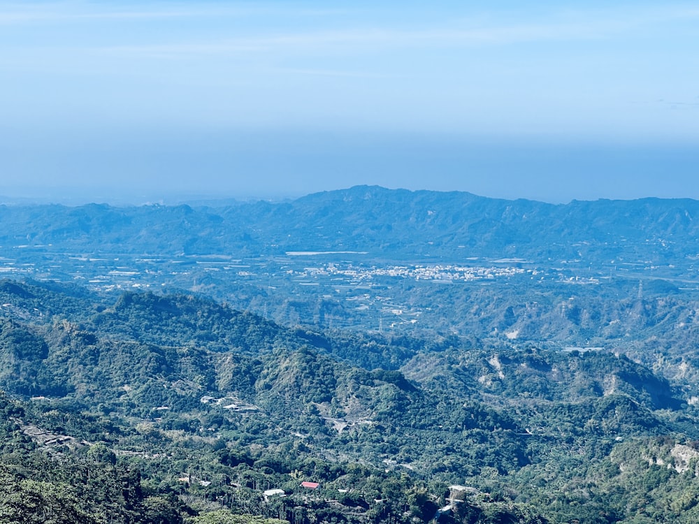 a view of a valley with mountains in the background