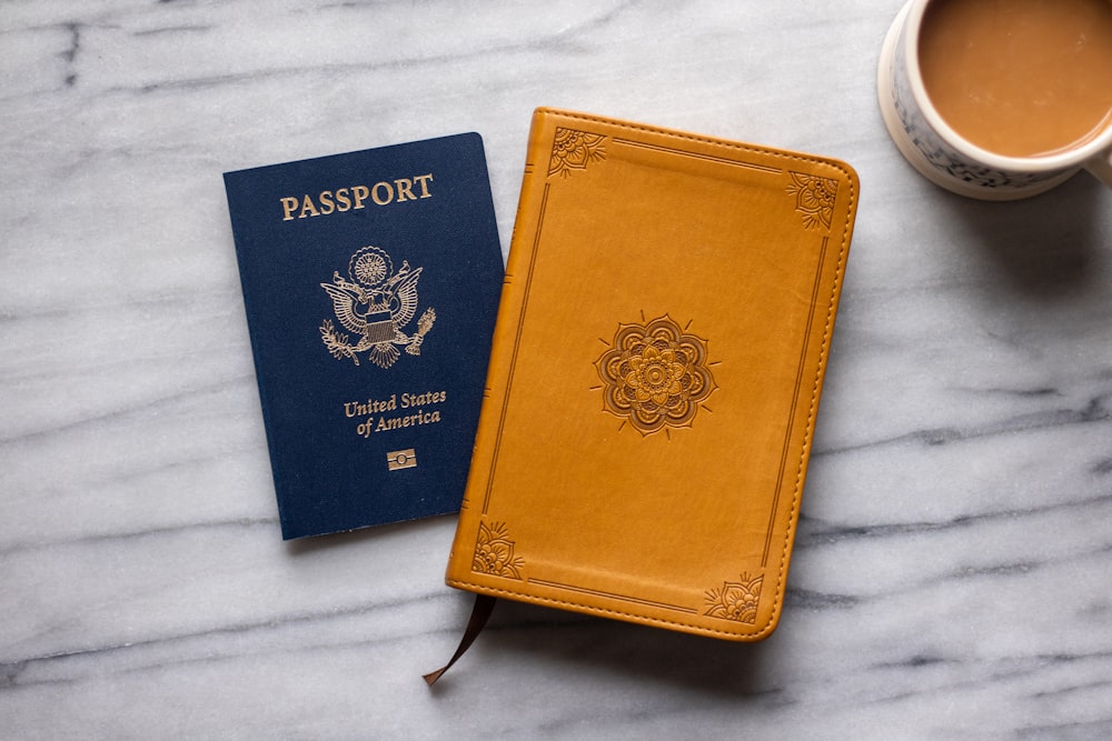 a passport and a cup of coffee on a marble table