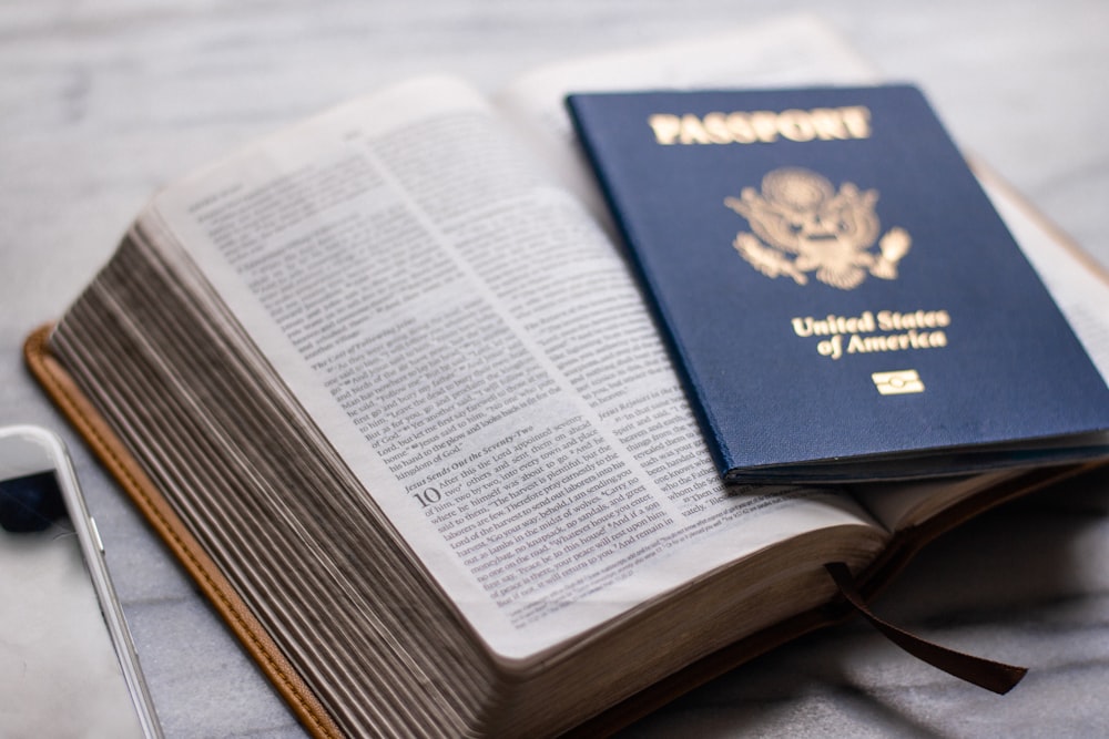 a passport sitting on top of an open book