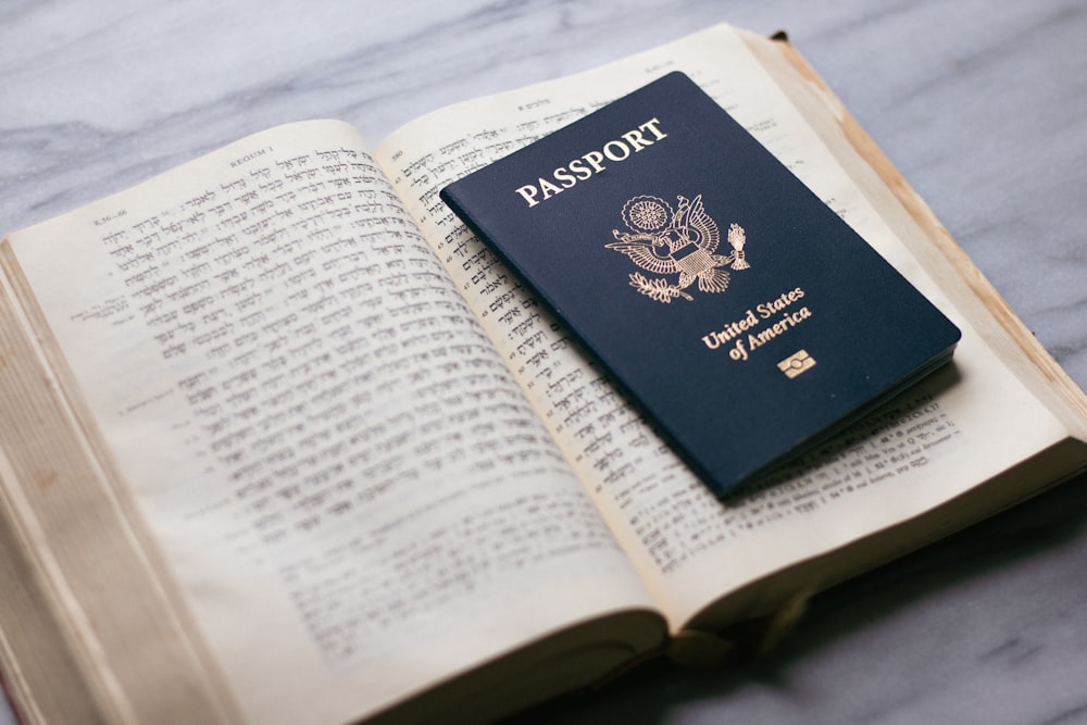 a passport sitting on top of an open book