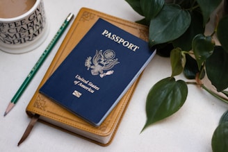 a passport sitting on top of a table next to a cup of coffee