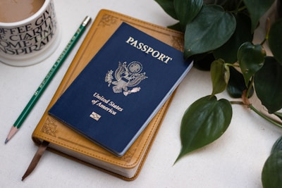 a passport sitting on top of a table next to a cup of coffee