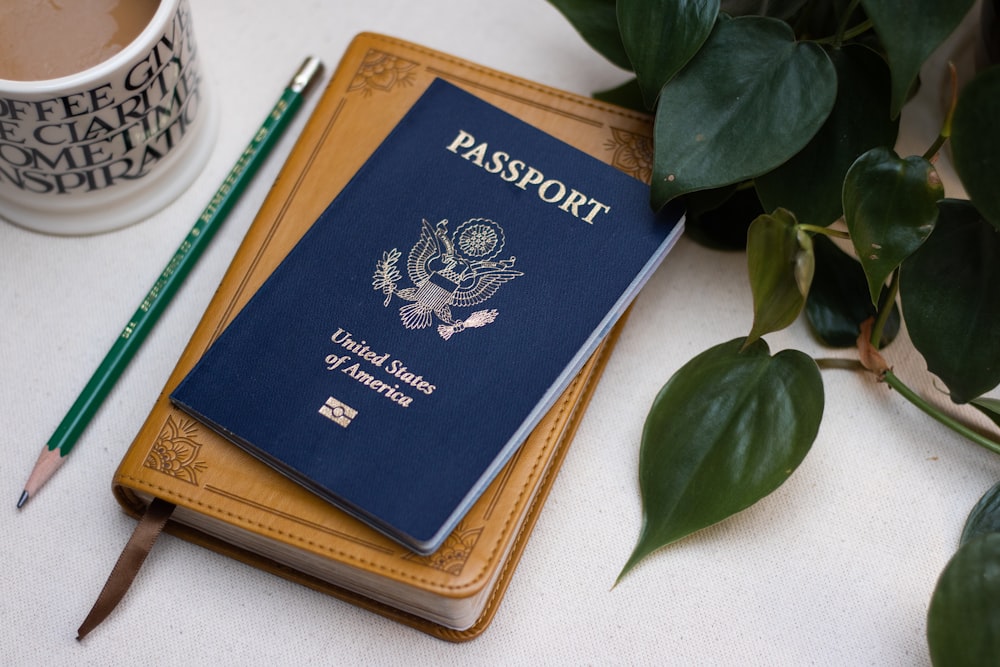 a passport sitting on top of a table next to a cup of coffee