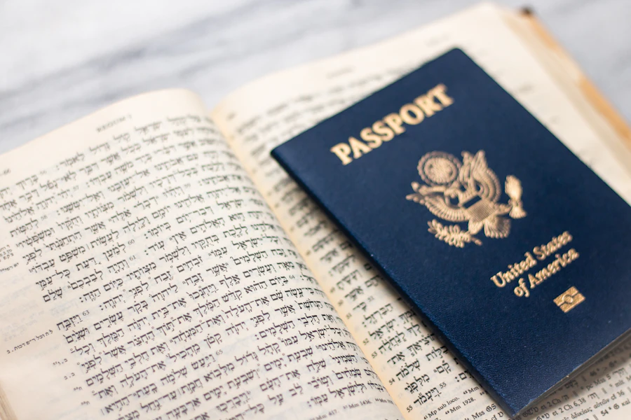 A passport resting on the open pages of a Bible