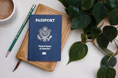 a passport sitting on top of a table next to a cup of coffee