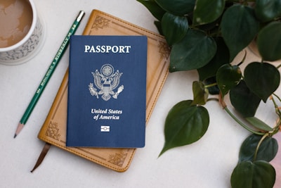 a passport sitting on top of a table next to a cup of coffee