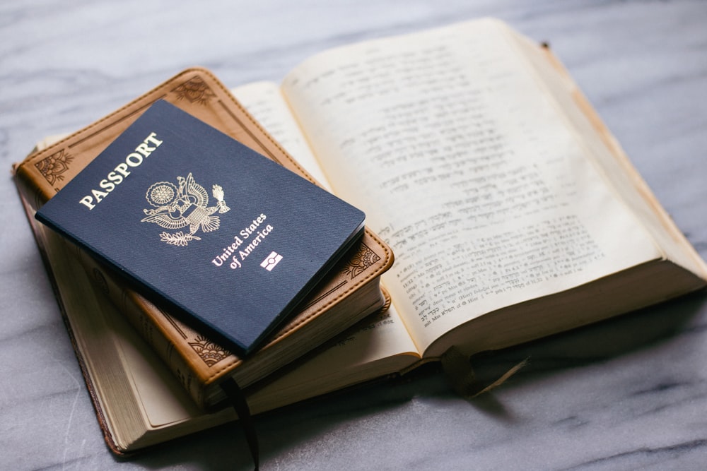 a passport sitting on top of an open book