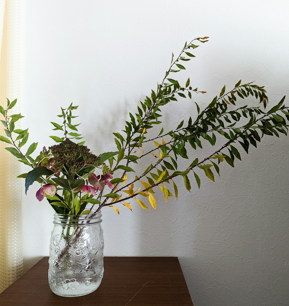 a vase filled with flowers on top of a wooden table