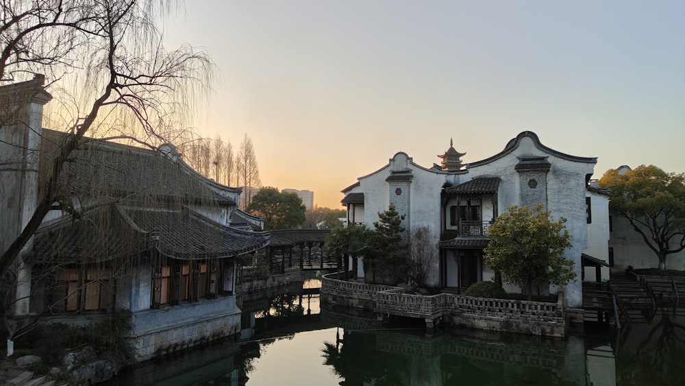 a river running through a village next to tall buildings