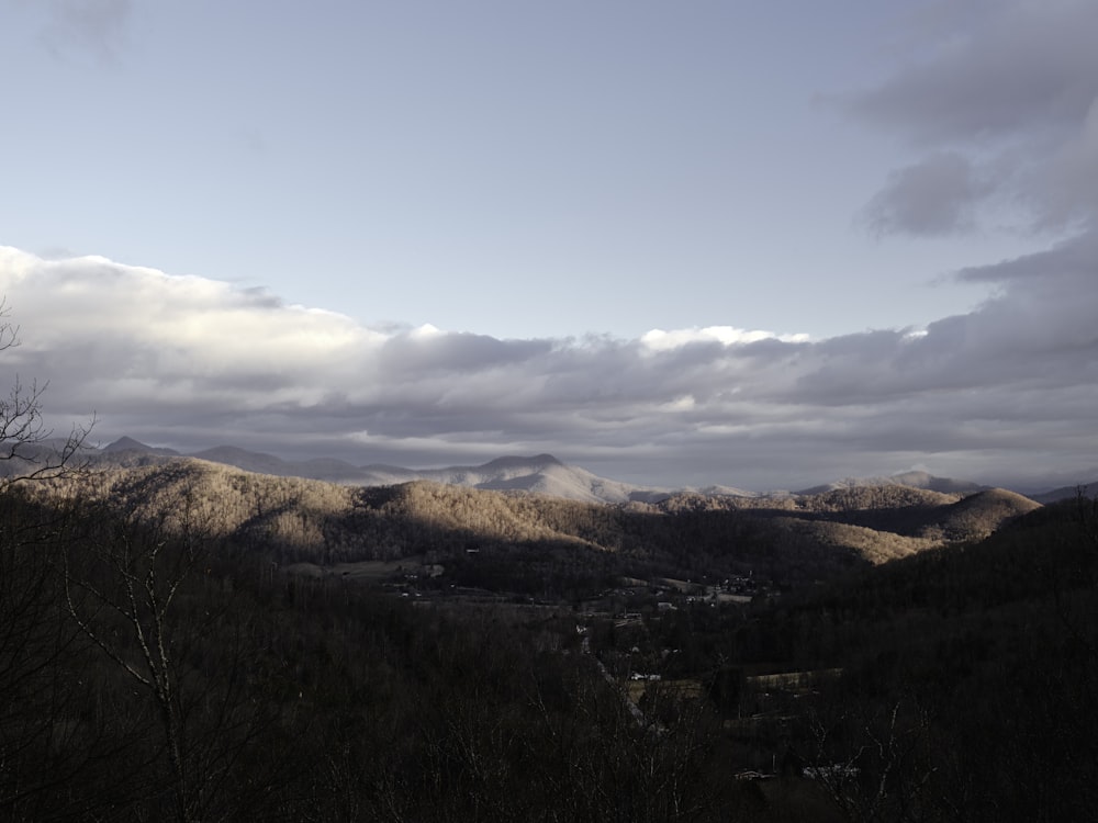 a view of a valley with mountains in the background