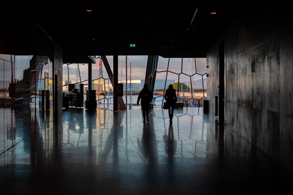 a person standing in a room with large windows