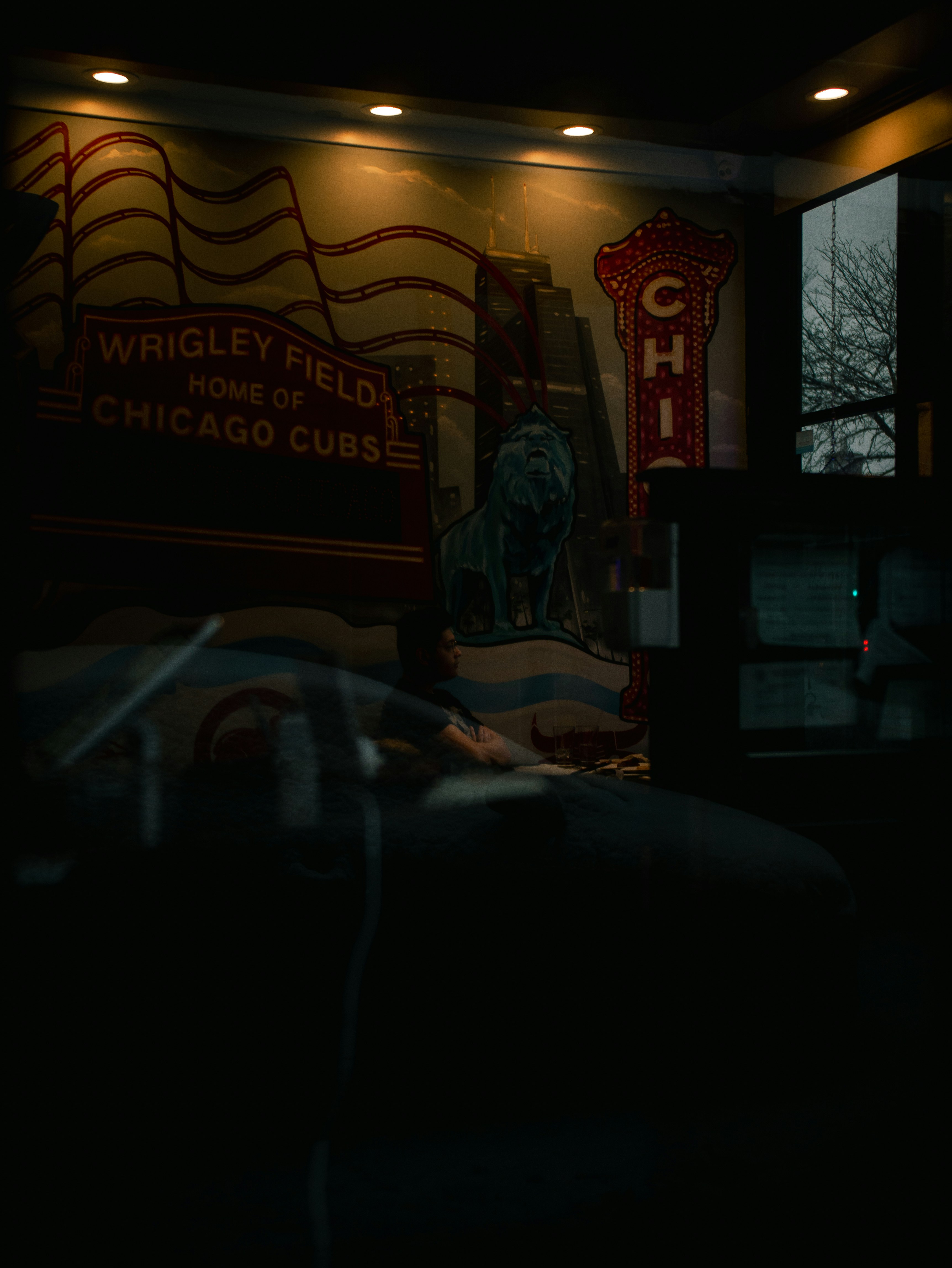 a dark room with a neon sign on the wall