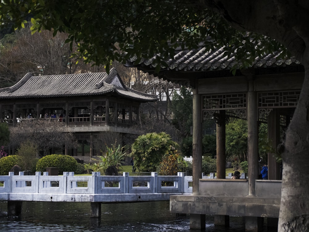 a bridge over a body of water with a building in the background